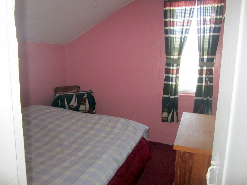 102 South Main Road Otis, MA 01253 - Photo 12 of 25 a bedroom with a bed and a chair