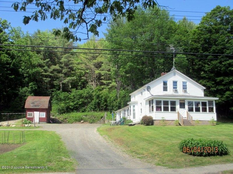 102 South Main Road Otis, MA 01253 - Photo 3 of 25 a front view of a house with a yard