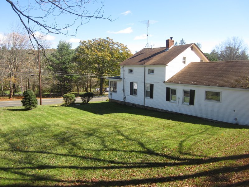 102 South Main Road Otis, MA 01253 - Photo 4 of 25 a view of a house with a backyard