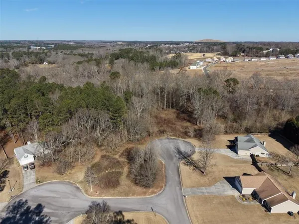 an aerial view of a houses with ocean view