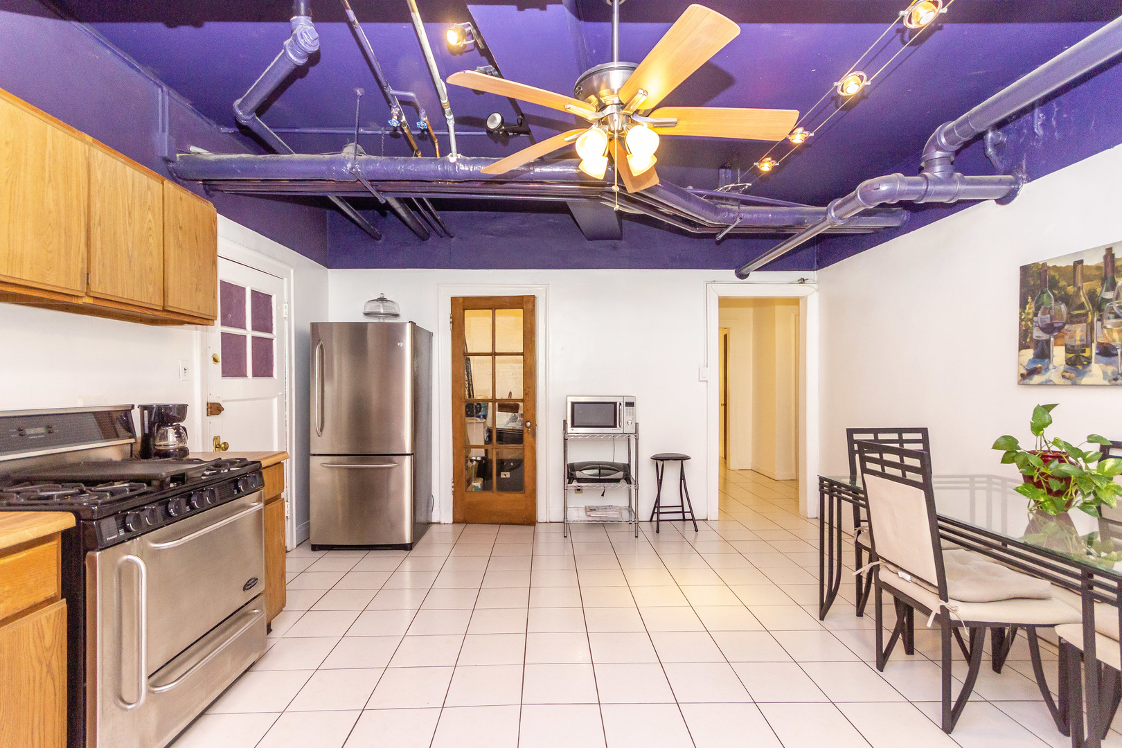 1360 East Madison Park, Unit B Chicago, IL 60615 - Photo 17 of 19 a kitchen with a refrigerator a table and chairs in it