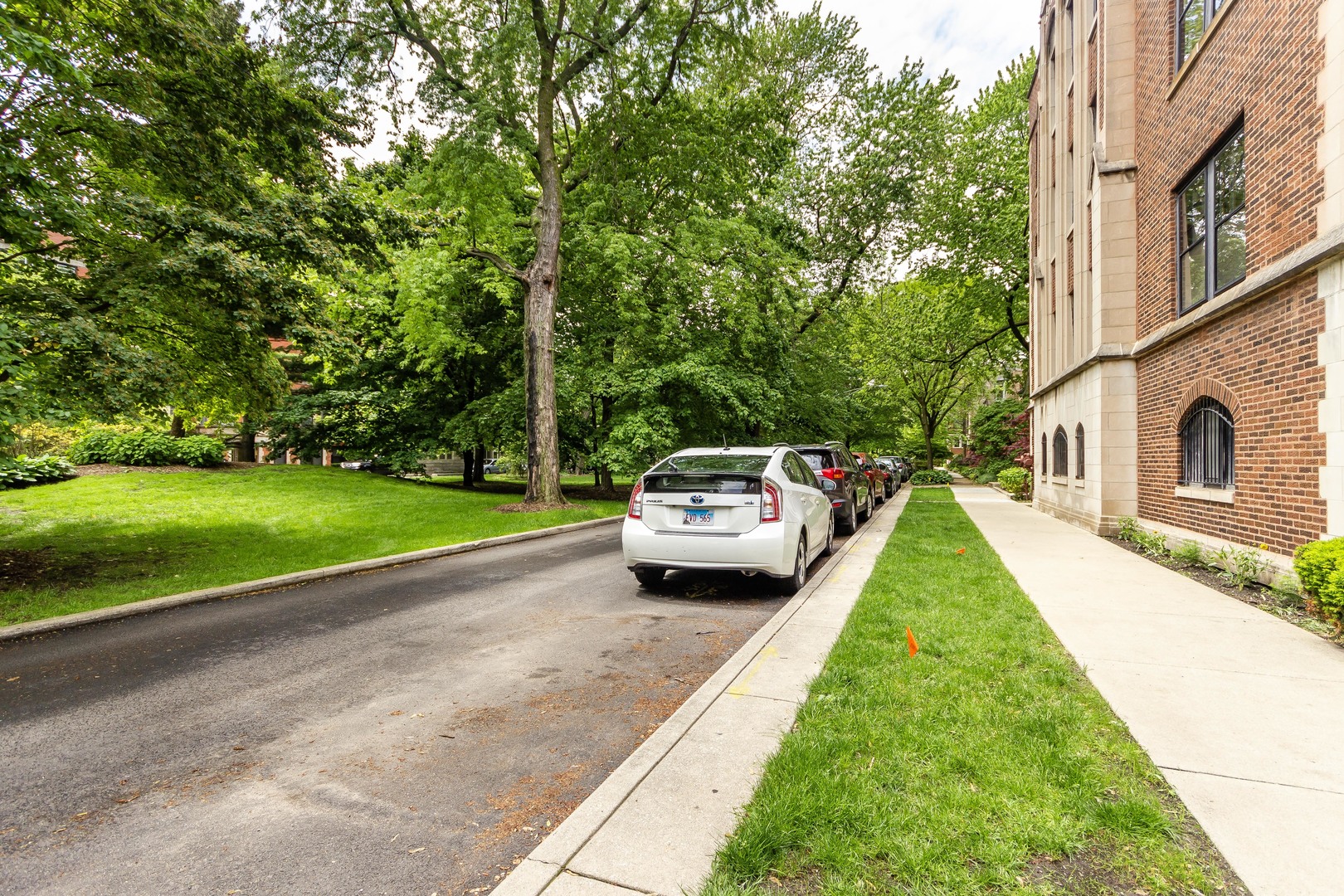 1360 East Madison Park, Unit B Chicago, IL 60615 - Photo 6 of 19 a car parked in front of a house with a big yard