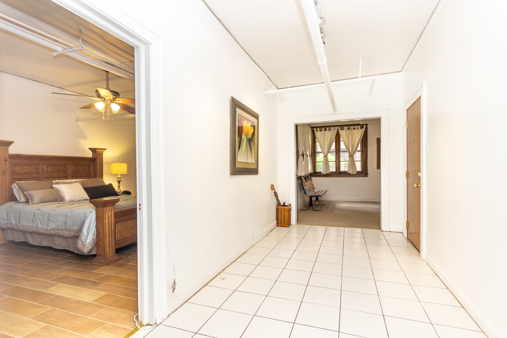 1360 East Madison Park, Unit B Chicago, IL 60615 - Photo 8 of 19 a view of a bedroom with a bed and glass door