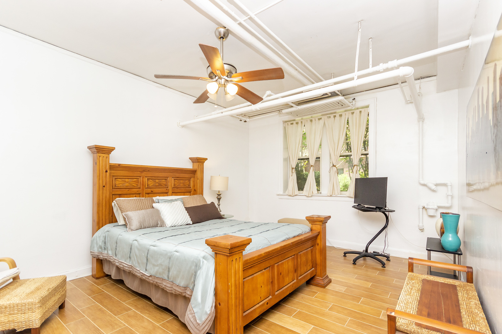 1360 East Madison Park, Unit B Chicago, IL 60615 - Photo 9 of 19 a bedroom with a bed and wooden floor