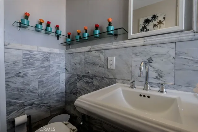a bathroom with a sink mirror and toilet