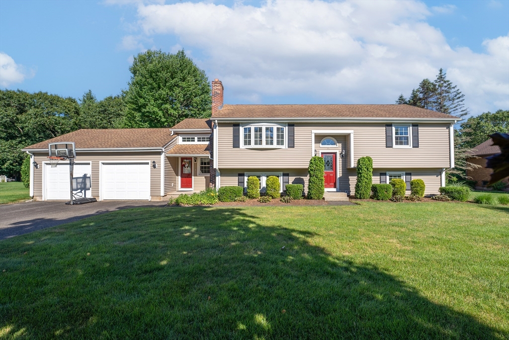 47 Deer Run Road West Springfield, MA 01089 - Photo 5 of 41 a front view of a house with a yard and garage