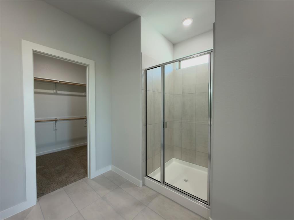 120 Millwood Road Lavon, TX 75166 - Photo 14 of 34 Walk-in shower with clear glass enclosure and light-toned tile surround