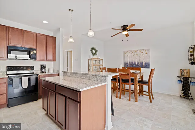 a large kitchen with stainless steel appliances granite countertop a stove sink and cabinets