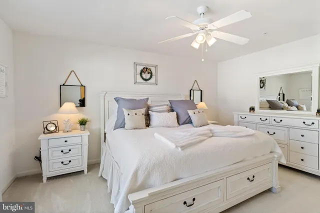 a spacious bedroom with a bed and a flat screen tv