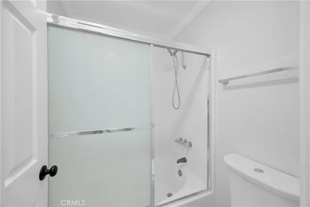 a bathroom with a shower and a toilet