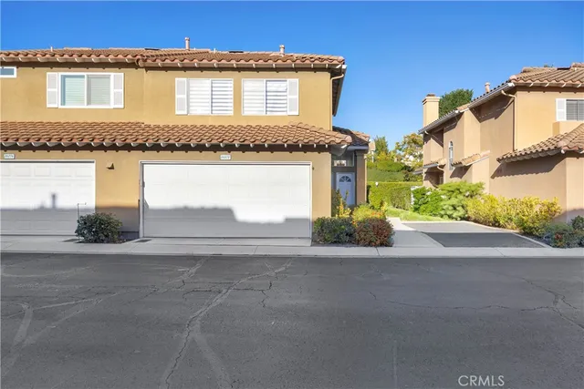 a view of a house with a yard and garage