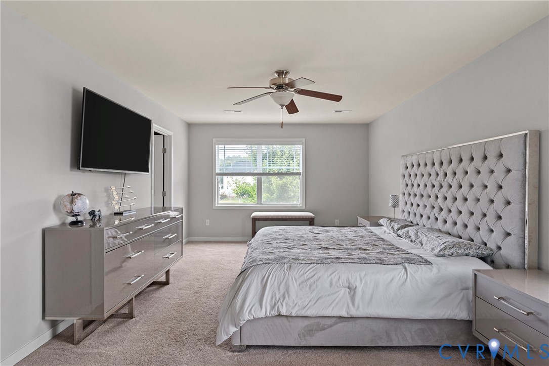 11223 Hill Ridge Court Ashland, VA 23005 - Photo 20 of 35 a spacious bedroom with a bed and a flat screen tv