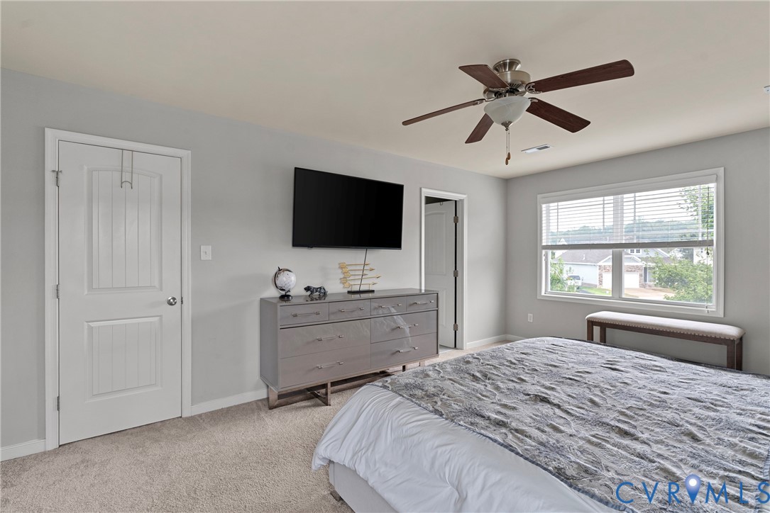11223 Hill Ridge Court Ashland, VA 23005 - Photo 21 of 35 a bedroom with a large bed and a flat screen tv