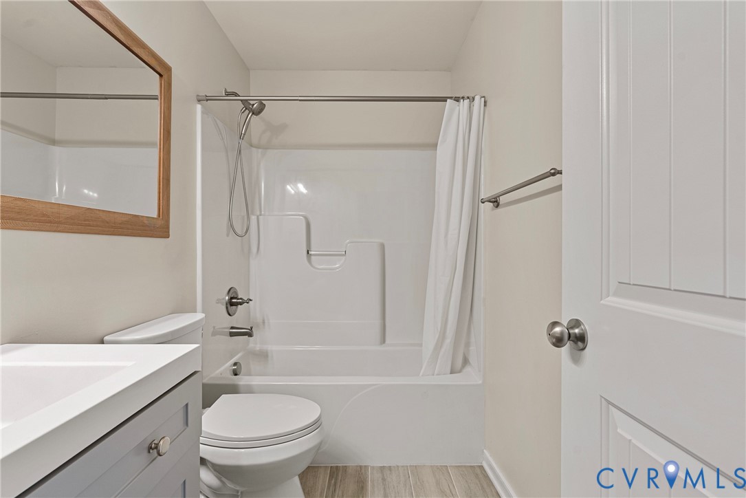 11223 Hill Ridge Court Ashland, VA 23005 - Photo 26 of 35 a bathroom with a granite countertop sink toilet and shower