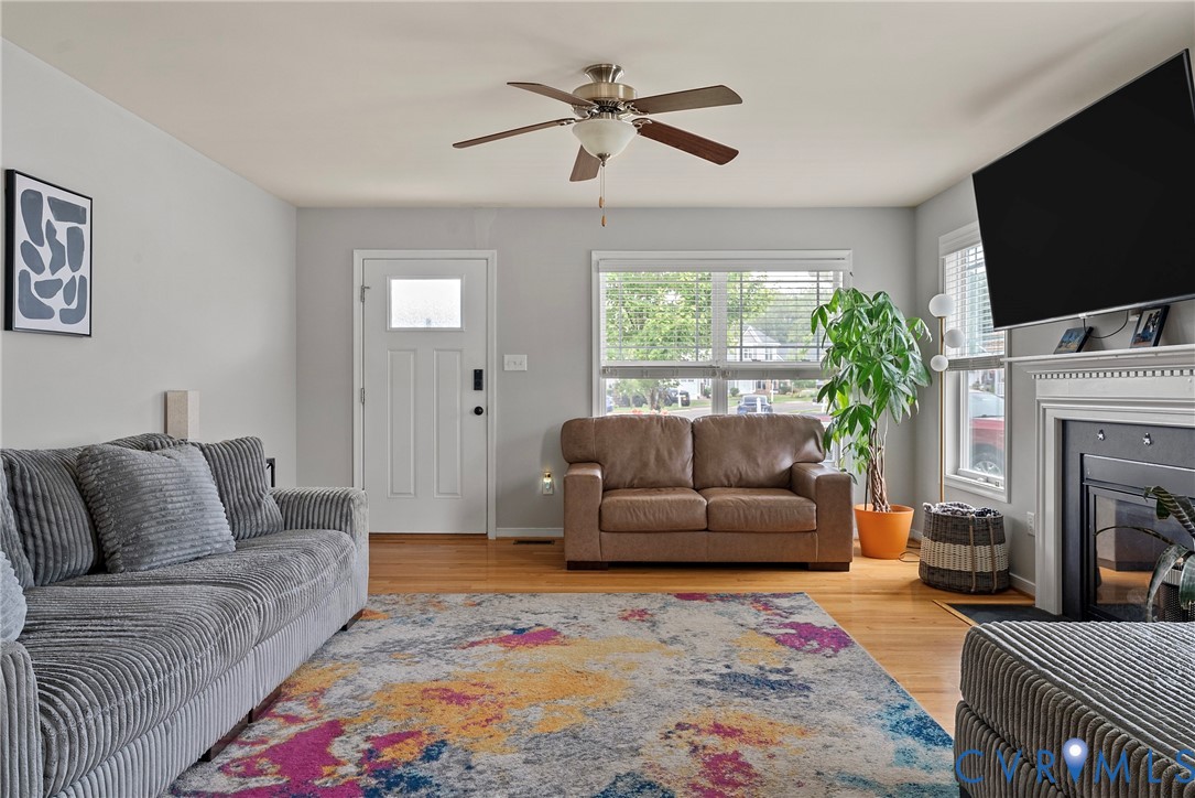 11223 Hill Ridge Court Ashland, VA 23005 - Photo 5 of 35 a living room with furniture a flat screen tv and a fireplace