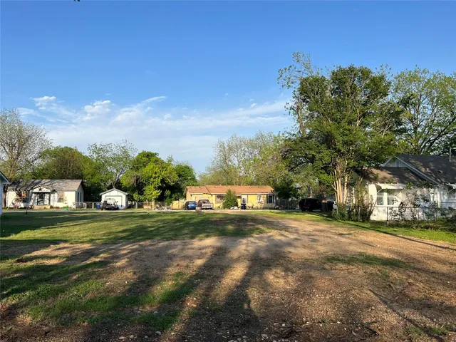 a view of a park with large trees