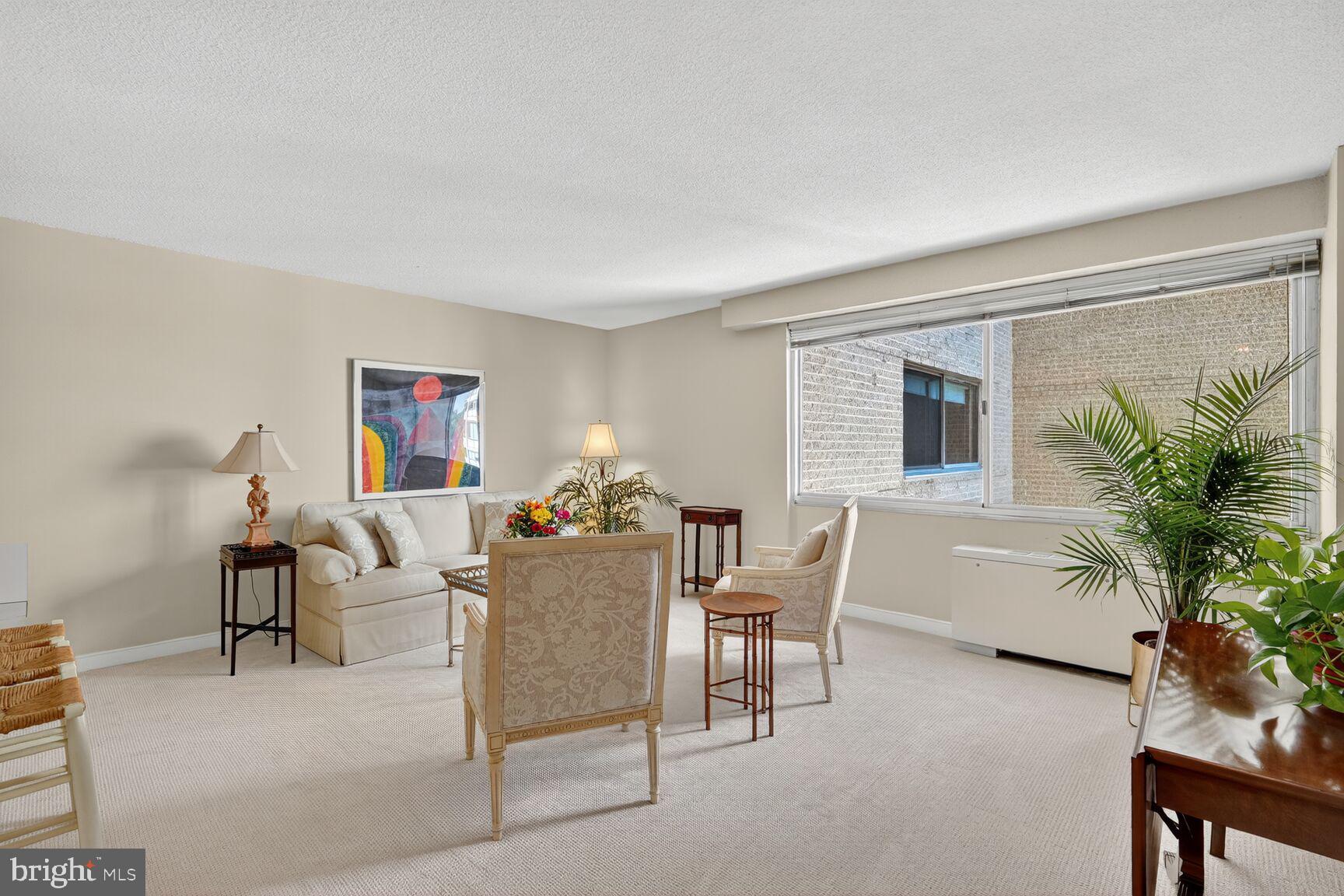 4515 Willard Avenue, Unit 1421S Chevy Chase, MD 20815 - Photo 11 of 53 a living room with furniture a potted plant and a table