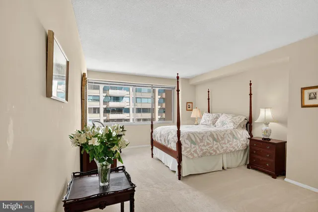 a bed room with a bed and a large window