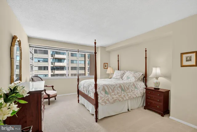 a bedroom with a large bed and a dresser