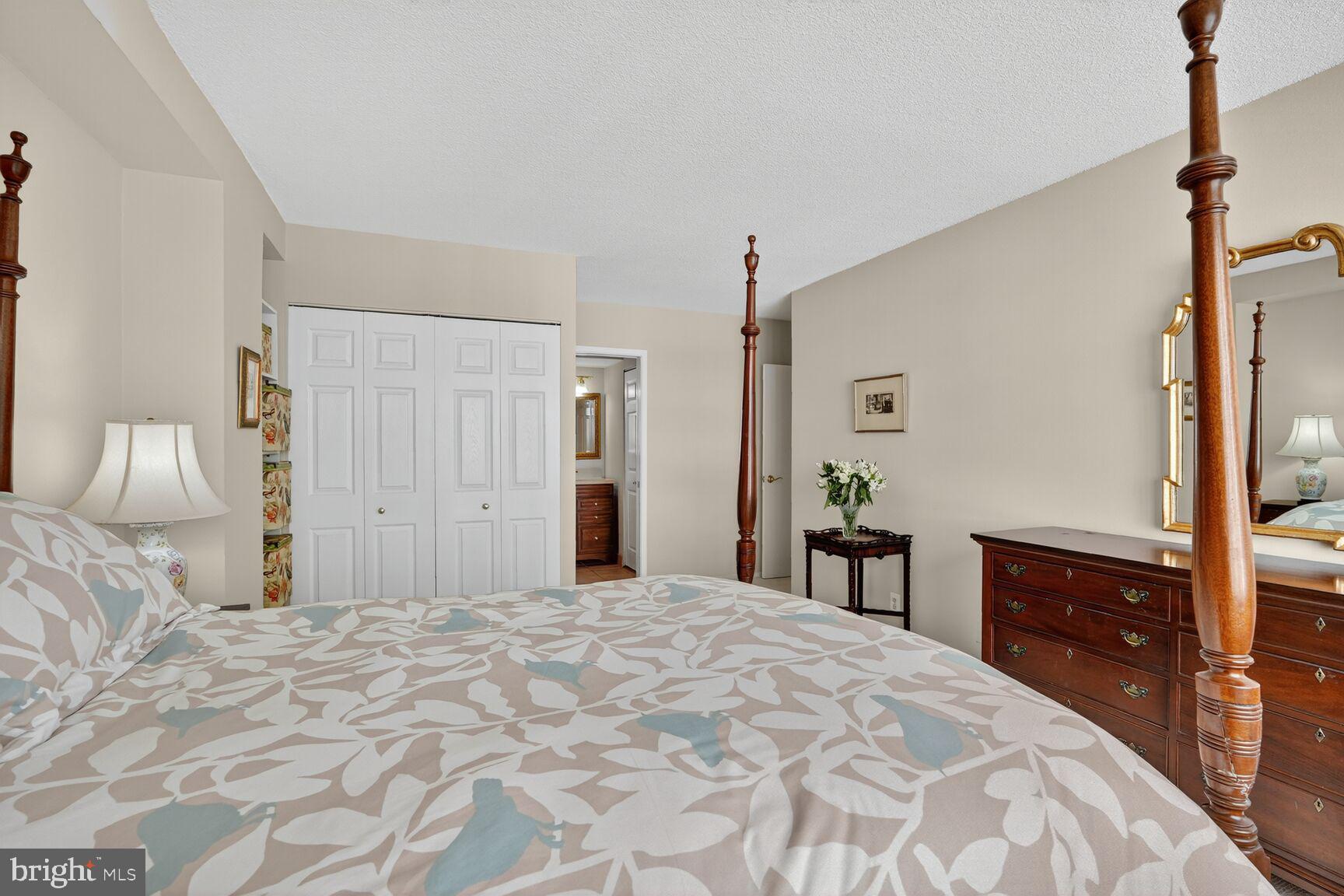 4515 Willard Avenue, Unit 1421S Chevy Chase, MD 20815 - Photo 15 of 53 a bedroom with a large bed and a dresser