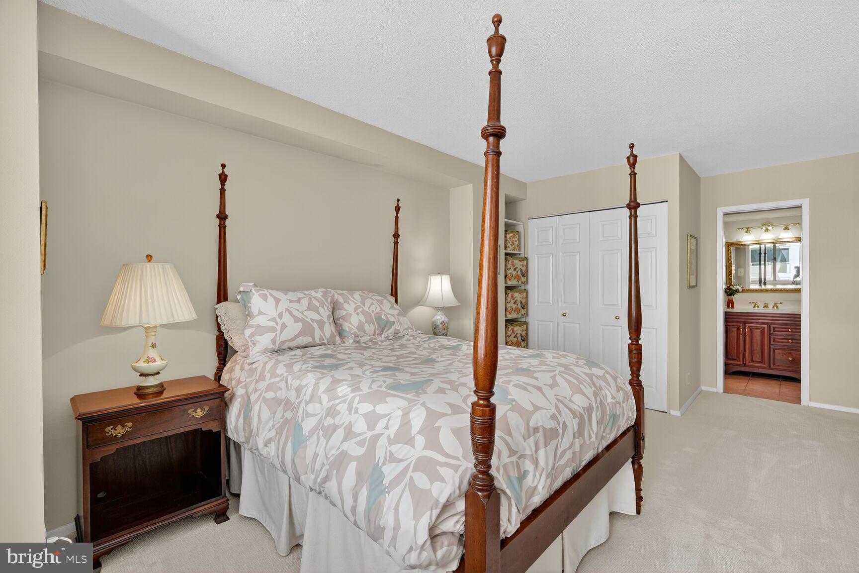 4515 Willard Avenue, Unit 1421S Chevy Chase, MD 20815 - Photo 16 of 53 a bed room with a bed and a lamp