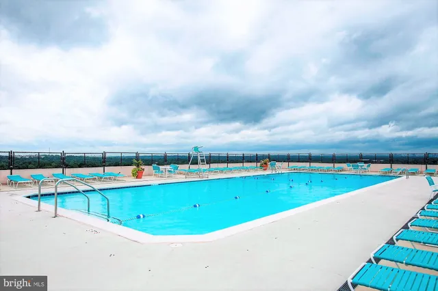 a view of a swimming pool and a yard