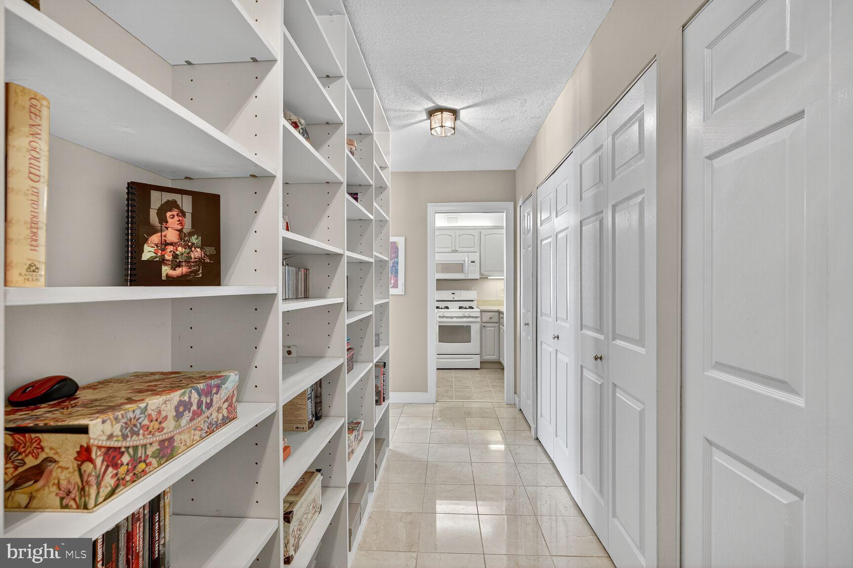4515 Willard Avenue, Unit 1421S Chevy Chase, MD 20815 - Photo 6 of 53 a view of a hallway with closet and racks on the wall