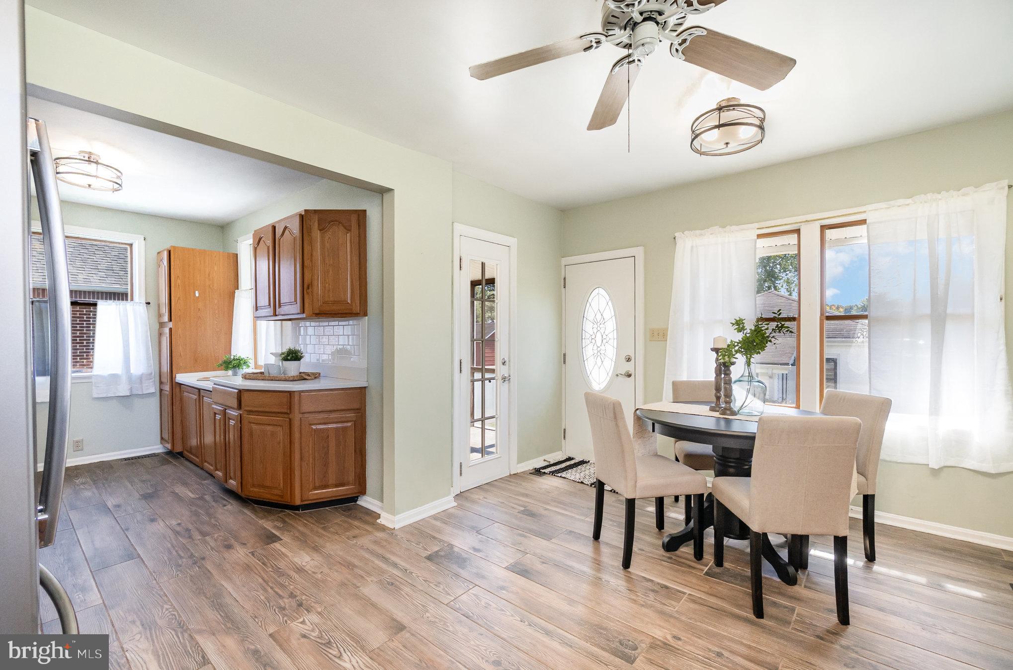 7401 Greenbank Road Baltimore, MD 21220 - Photo 12 of 58 a view of a dining room with furniture window and wooden floor