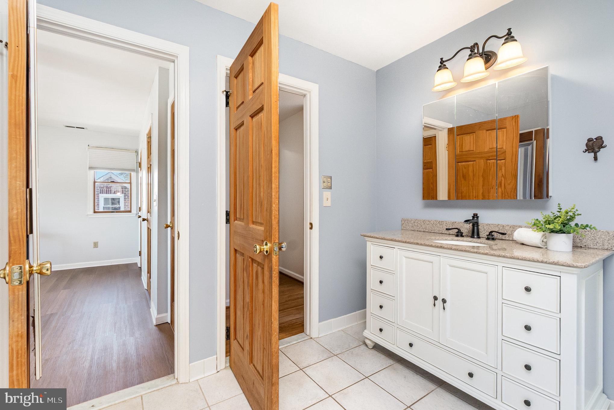7401 Greenbank Road Baltimore, MD 21220 - Photo 26 of 58 a spacious bathroom with a double vanity sink a mirror and a shower
