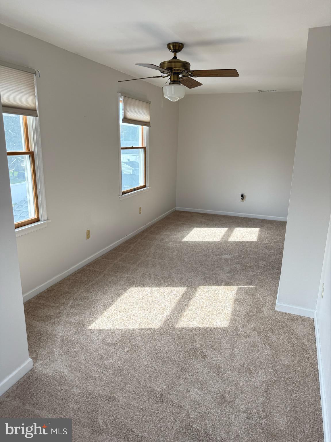 7401 Greenbank Road Baltimore, MD 21220 - Photo 28 of 58 an empty room with windows and ceiling fan