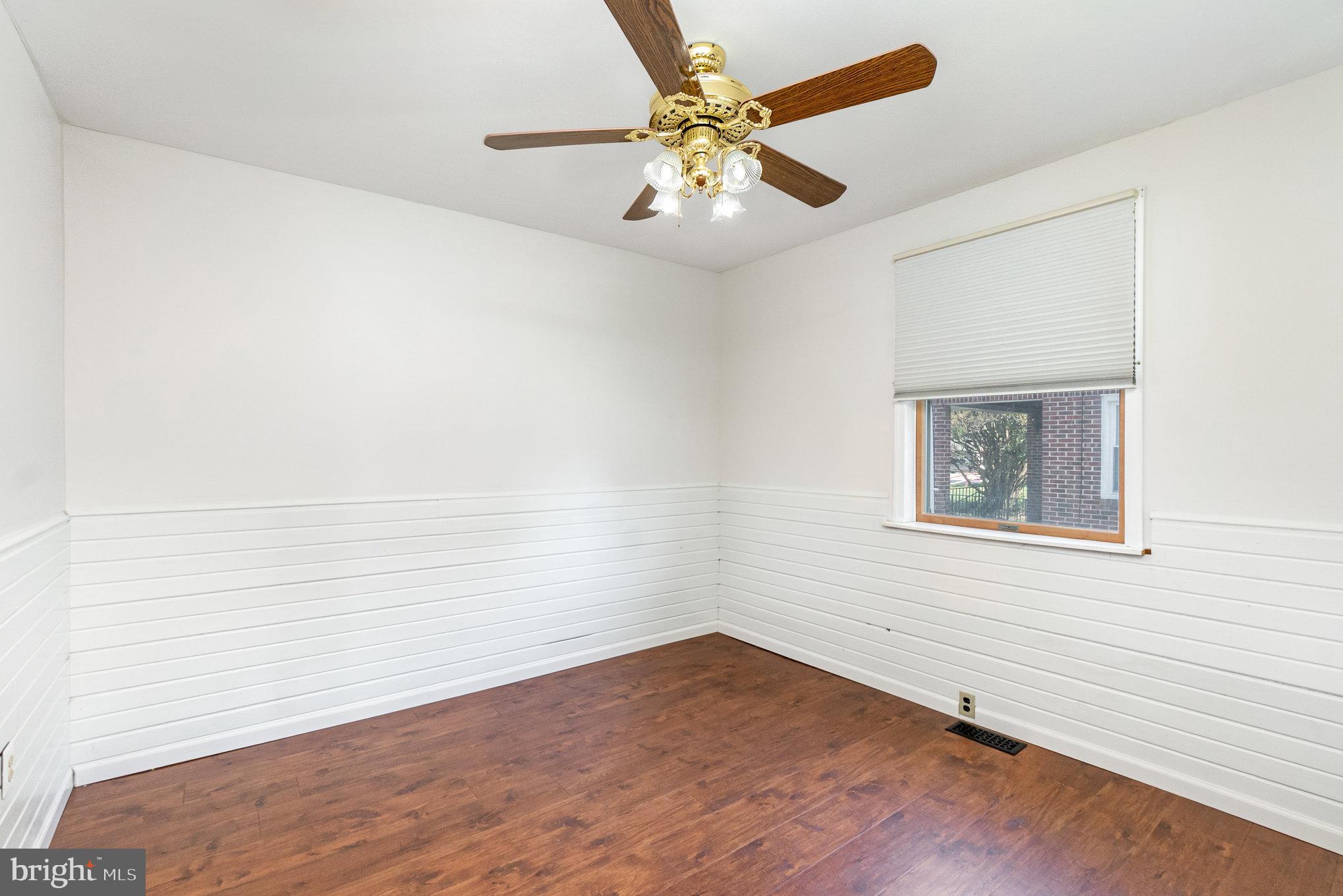 7401 Greenbank Road Baltimore, MD 21220 - Photo 34 of 58 an empty room with wooden floor and fan