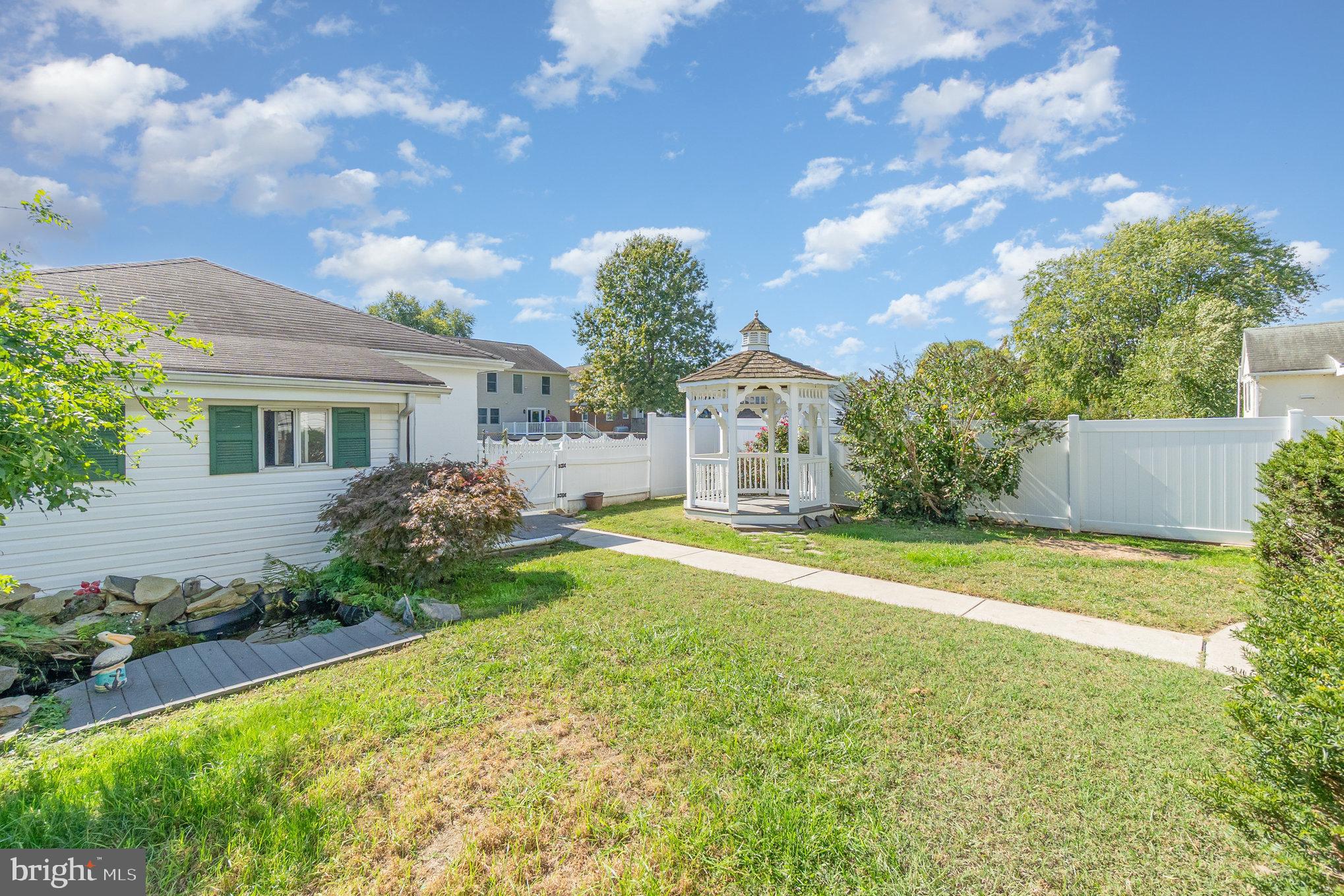 7401 Greenbank Road Baltimore, MD 21220 - Photo 41 of 58 a front view of a house with garden