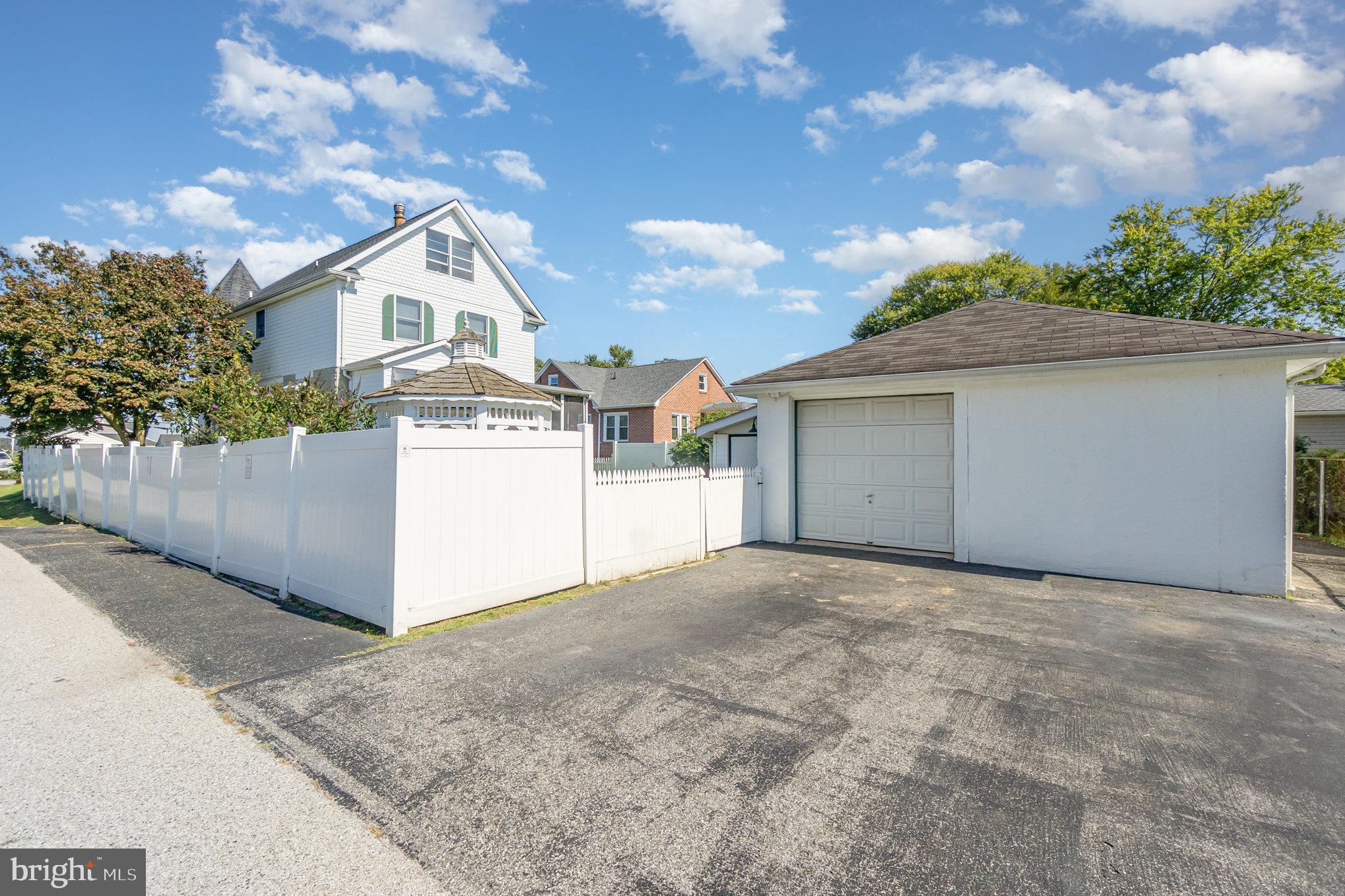 7401 Greenbank Road Baltimore, MD 21220 - Photo 43 of 58 a view of a house with a garage and yard