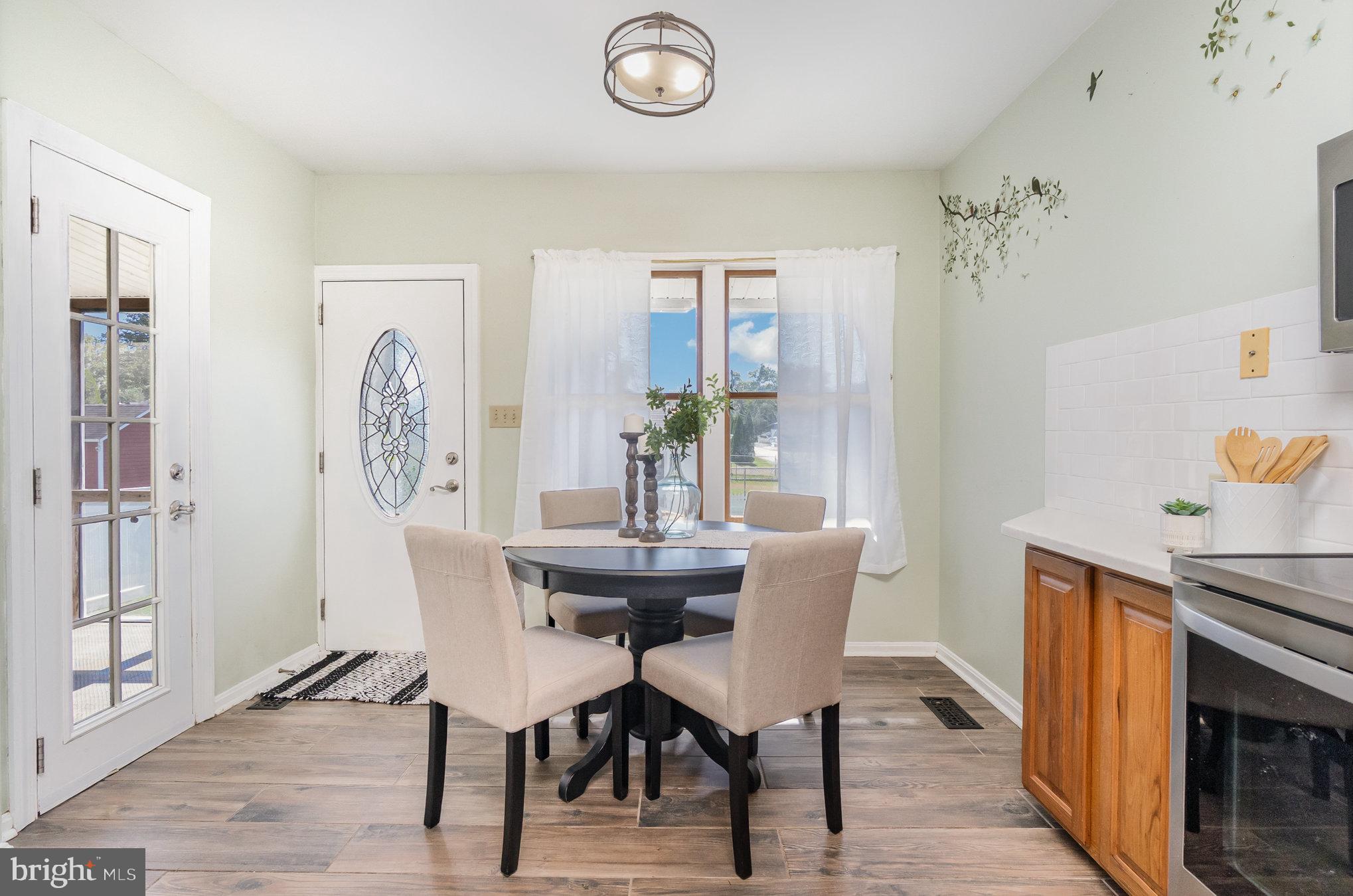 7401 Greenbank Road Baltimore, MD 21220 - Photo 10 of 58 a view of a dining room with furniture and wooden floor