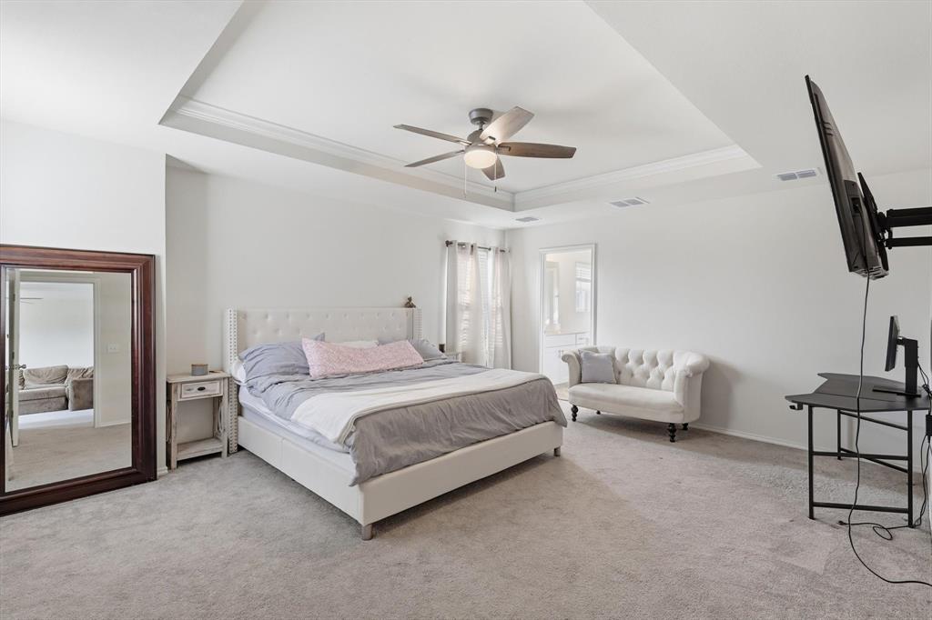 16041 Pious Drive Haslet, TX 76052 - Photo 15 of 36 Bedroom with a raise inset ceiling, carpet, ceiling fan