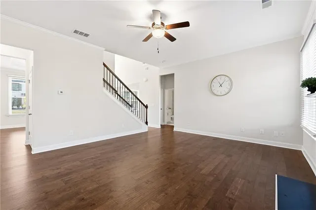 a view of an empty room with wooden floor