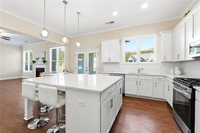 a kitchen with a sink a stove a refrigerator and cabinets