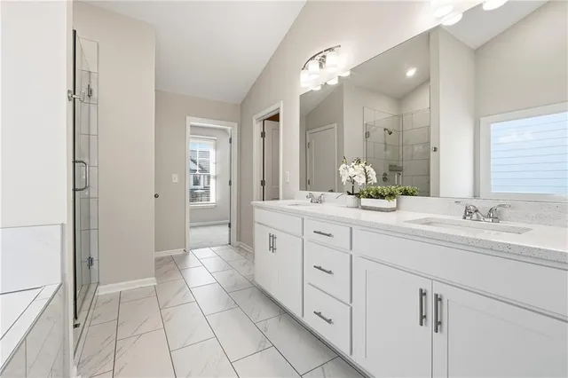 a spacious bathroom with a granite countertop sink mirror and
