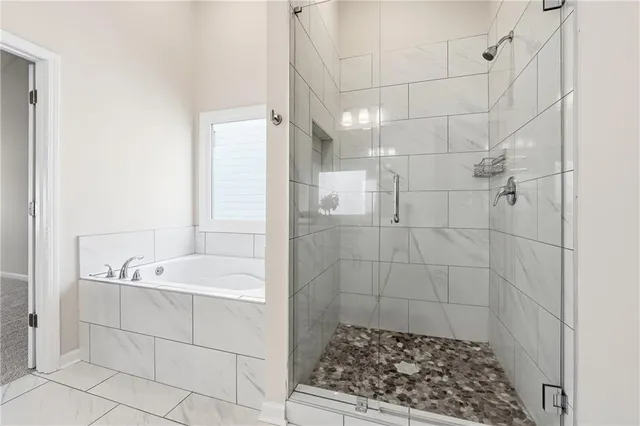 a bathroom with a bathtub and shower