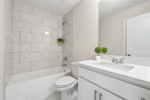 a bathroom with a sink a toilet and bathtub