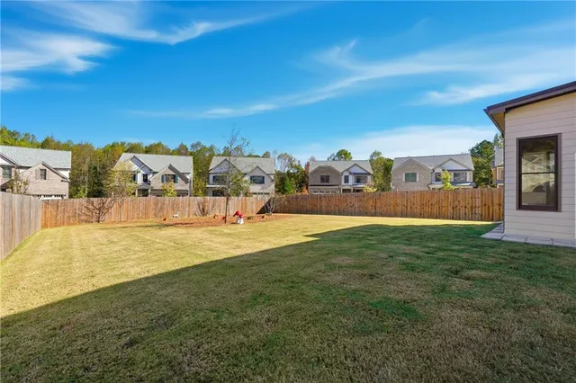 a view of house with yard and front view of house