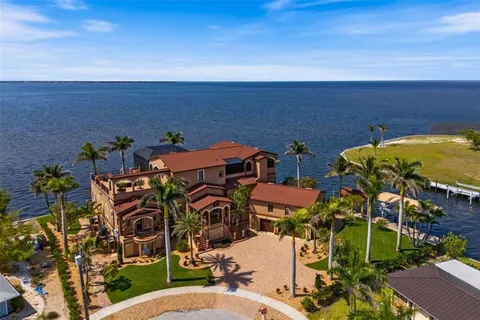 a front view of a building with a garden and plants