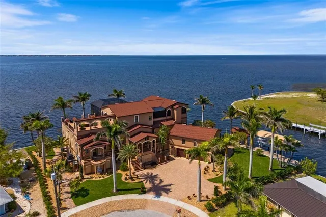 a front view of a building with a garden and plants