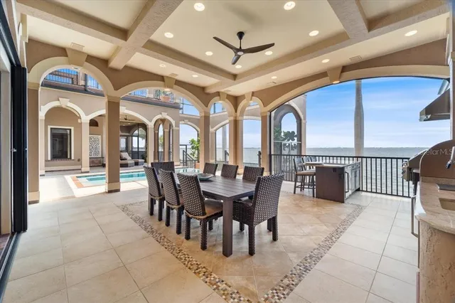 a swimming pool with outdoor seating and barbeque oven