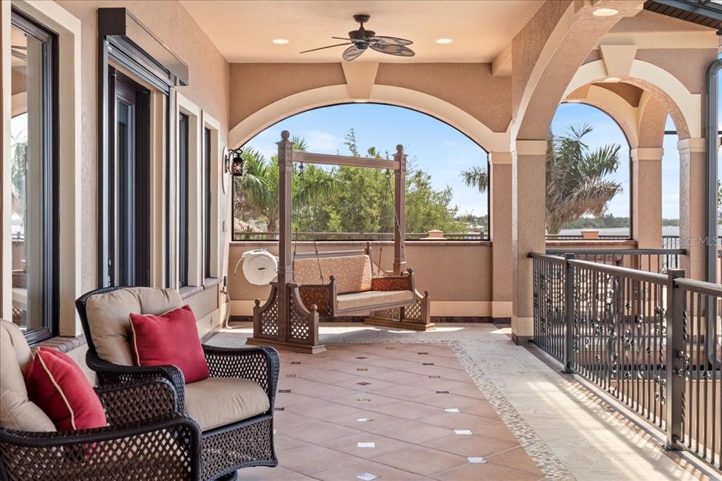 266 Bangsberg Road Southeast Port Charlotte, FL 33952 - Photo 27 of 100 a living room with furniture a fireplace and floor to ceiling windows