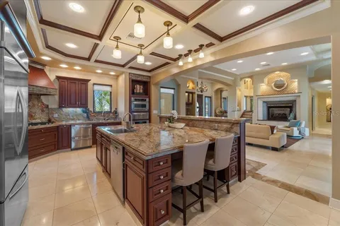 a living room with furniture a chandelier and a flat screen tv