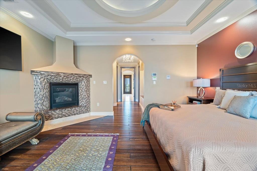 266 Bangsberg Road Southeast Port Charlotte, FL 33952 - Photo 47 of 100 a spacious bedroom with bed and a fireplace