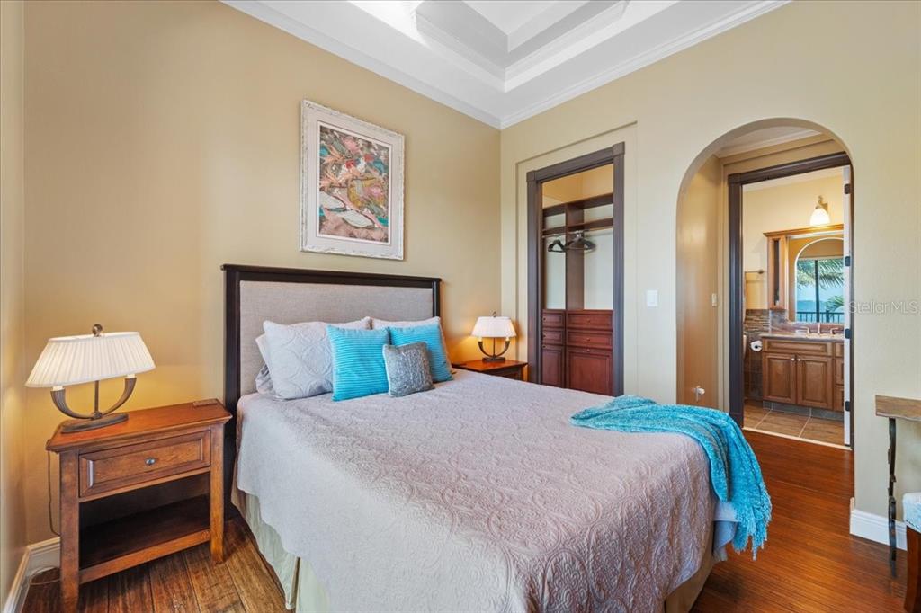 266 Bangsberg Road Southeast Port Charlotte, FL 33952 - Photo 60 of 100 a bedroom with a bed and wooden floor