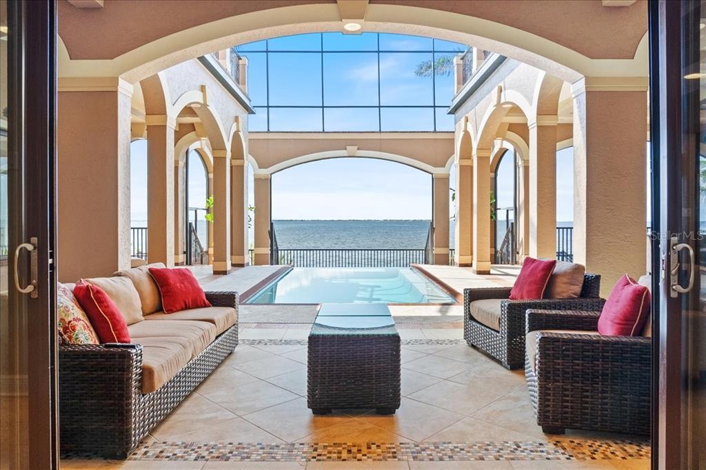 266 Bangsberg Road Southeast Port Charlotte, FL 33952 - Photo 6 of 100 a living room with furniture and a large window