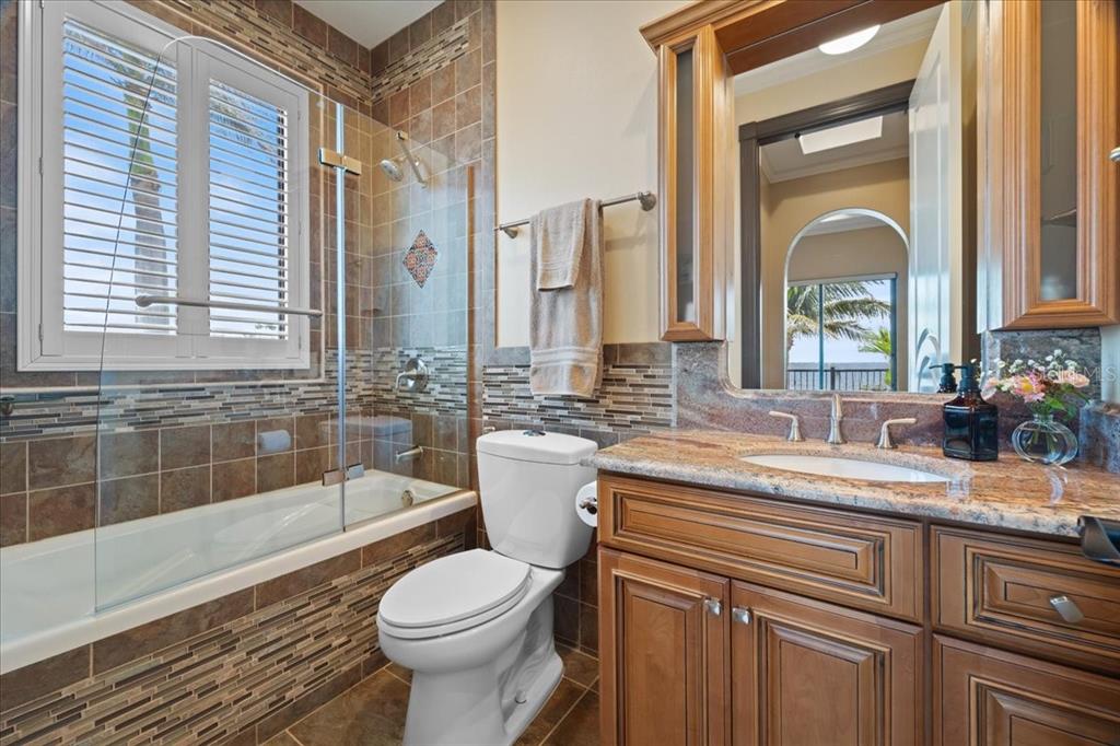 266 Bangsberg Road Southeast Port Charlotte, FL 33952 - Photo 61 of 100 a bathroom with a granite countertop toilet a sink and a bathtub